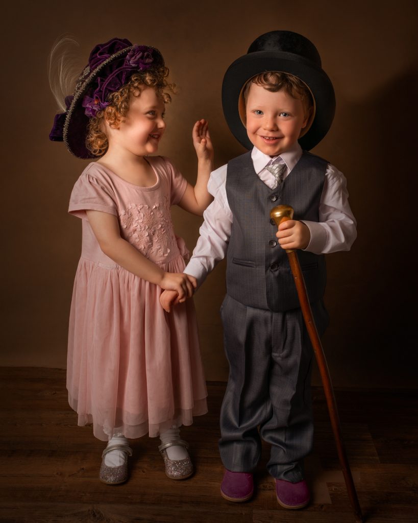 Twin boy and girl in victorian costume