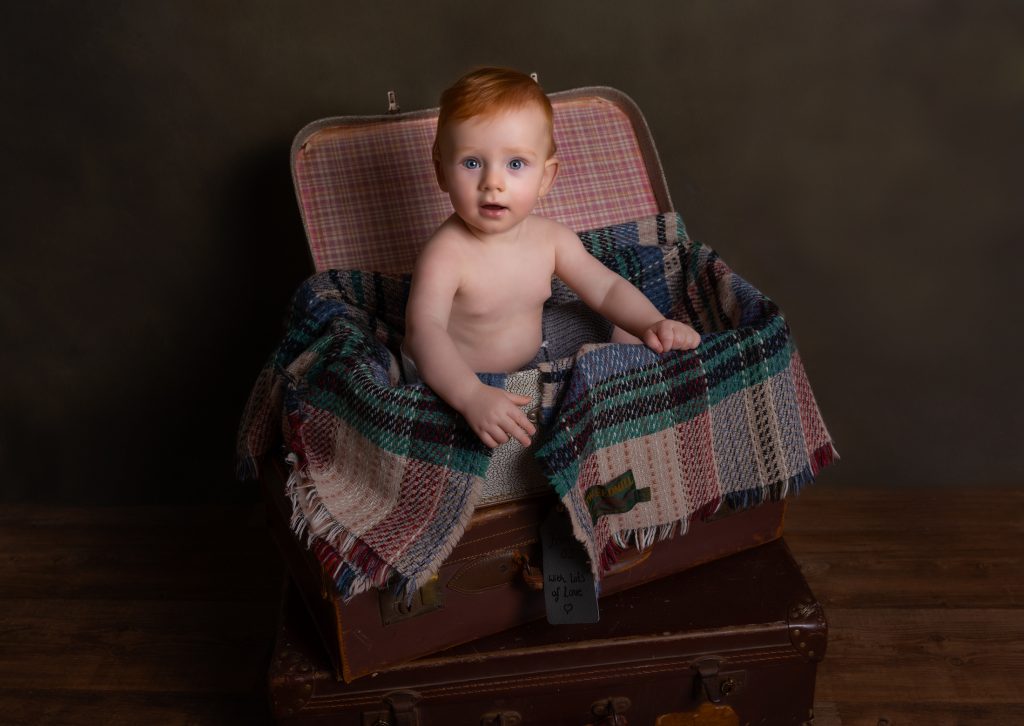 Baby in a suitcase with blanket