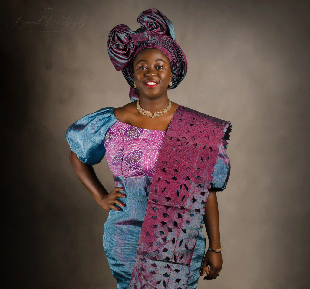 African woman in traditional dress with her hand on her hip