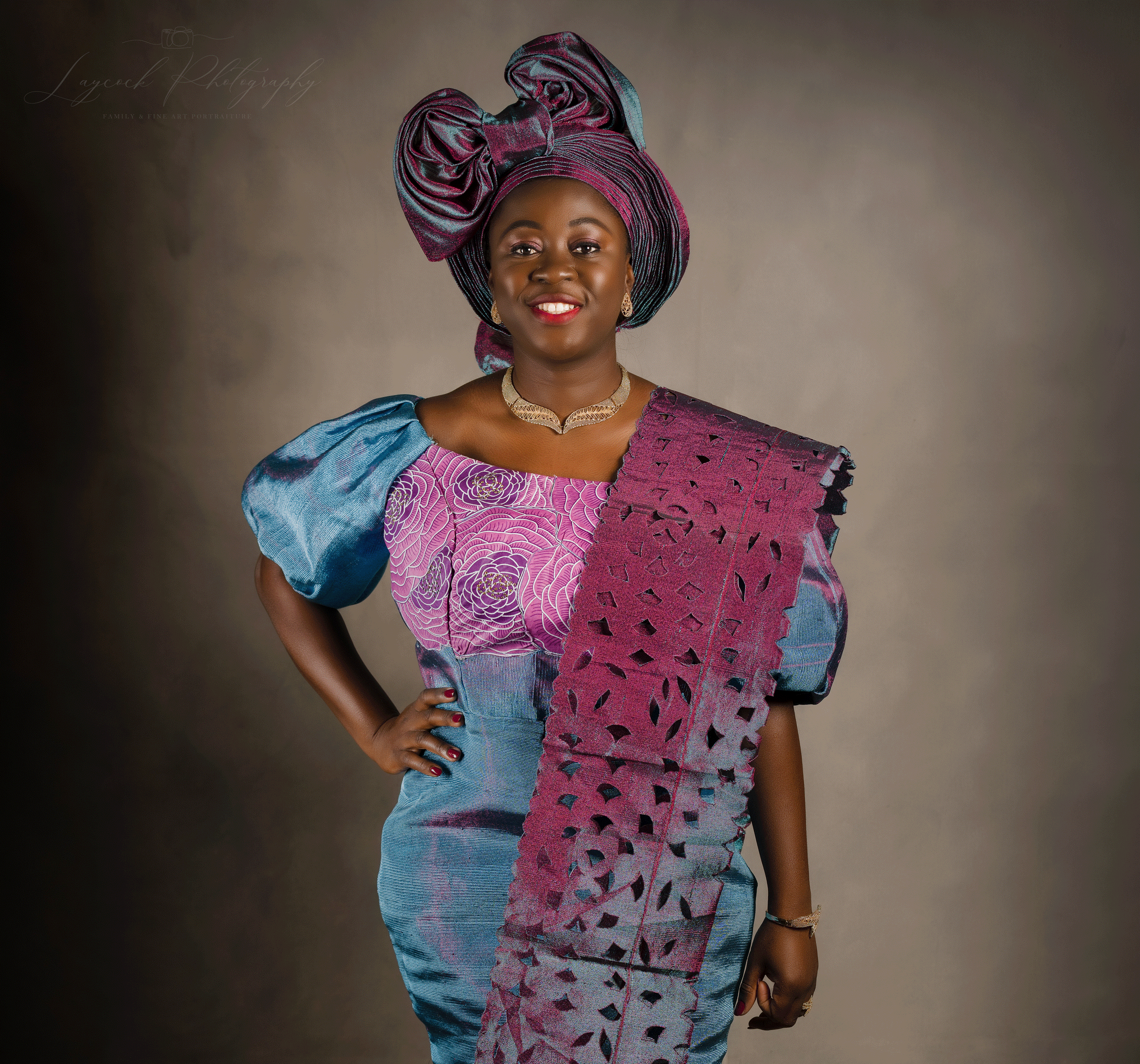 African woman in traditional dress with her hand on her hip