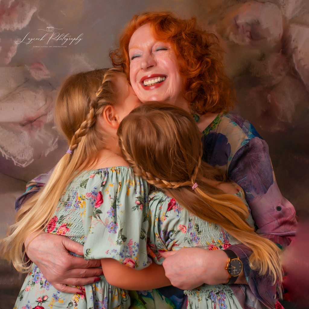 Grandmother and two grandchildren being embraced