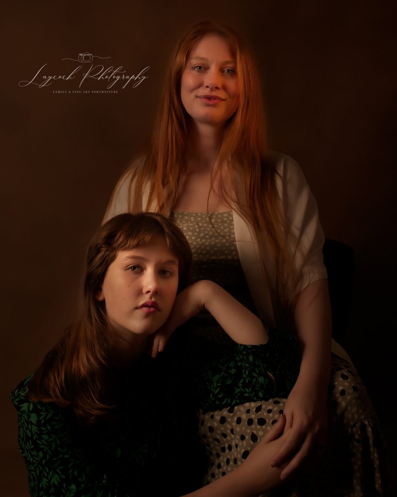 mother stood up and daughter sat on a chair